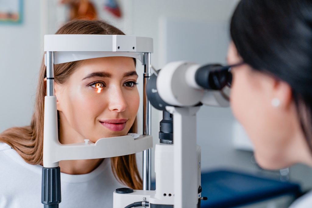 eye doctor with female patient during an examination in modern clinic