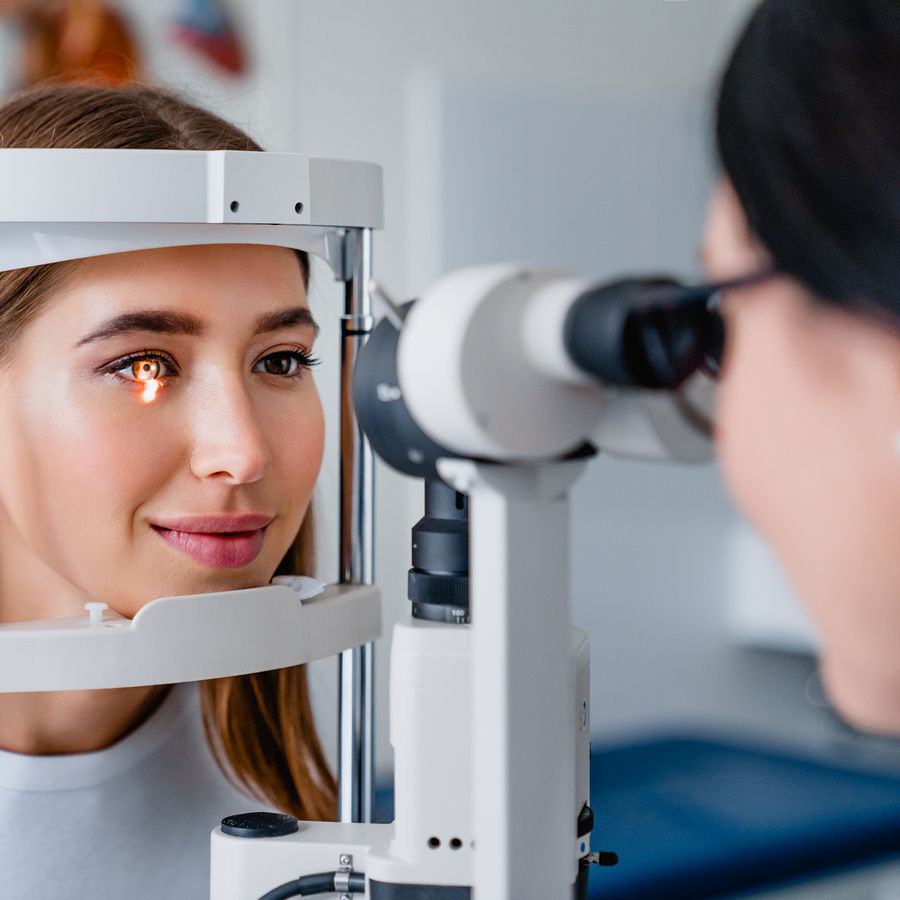 eye doctor with female patient during an examination in modern clinic