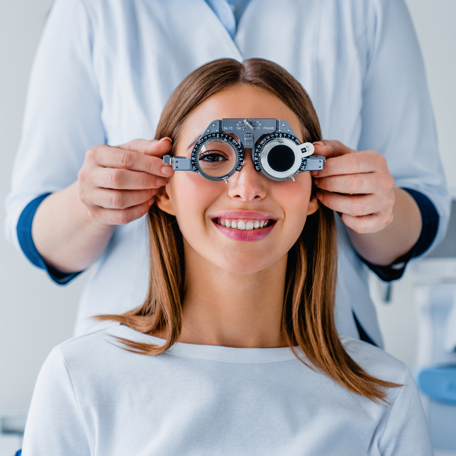 female patient checking vision in ophthalmological clinic