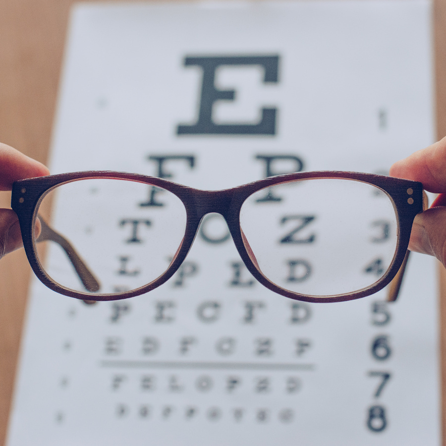 5292532 hands holding sight glasses in front of optician sight c